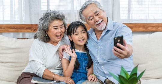 grandparents taking photo with grandchild